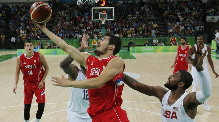 Serbia shoots as Kyrie Irving (USA) of the USA defends.