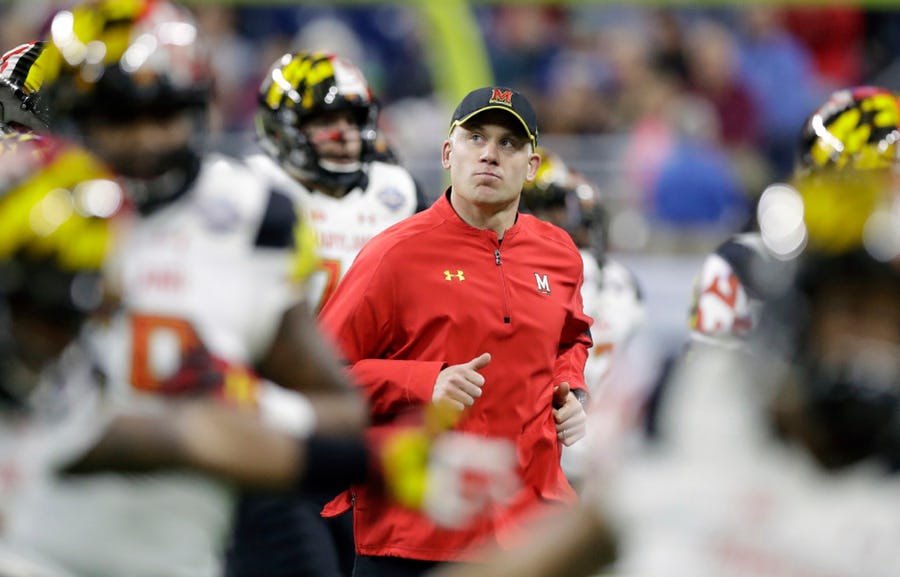 Maryland head coach DJ Durkin runs onto the field before the Quick Lane Bowl NCAA college football game against Boston College in Detroit.