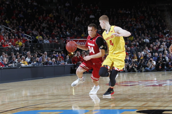 Wisconsin's Davison driving the ball against Maryland's Huerter