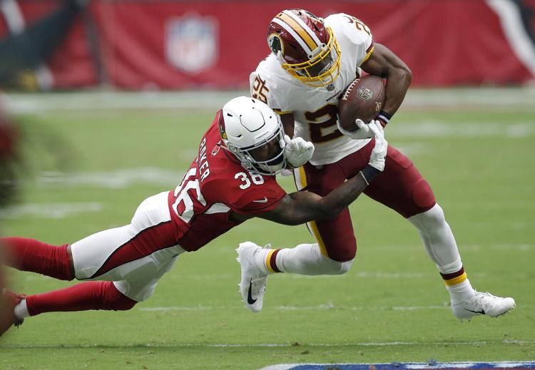 Washington Redskins running back Chris Thompson (25) is hit by Arizona Cardinals defensive back Budda Baker (36) during the first half of an NFL football game, Sunday, Sept. 9, 2018, in Glendale, Ariz. (AP Photo/Ross D. Franklin)