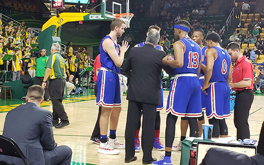 American players and coach during a timeout