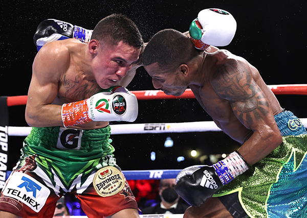 TUCSON, ARIZONA - SEPTEMBER 10: Oscar Valdez (L) and Robson Conceição (R) exchange punches during their fight for the WBC super featherweight championship