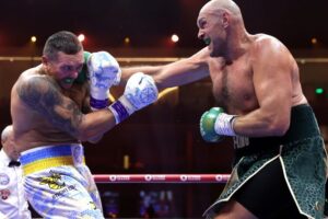 Tyson Fury hits Oleksandr Usyk with a jab in their first meeting. (Photo Courtesy: Mikey Williams/Top Rank)